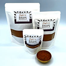 Load image into Gallery viewer, Image of Sashi's Biryani Masala in 3 packet sizes of 50g, 150g, and 200g. With some masala in a gold coloured metal bowl