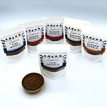 Load image into Gallery viewer, Image of the full range of Sashi's masalas. 6 packets of 50g masalas with Chai in front.