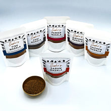 Load image into Gallery viewer, Image of the full range of Sashi's masalas. 6 packets of 50g masalas with Garam in front.